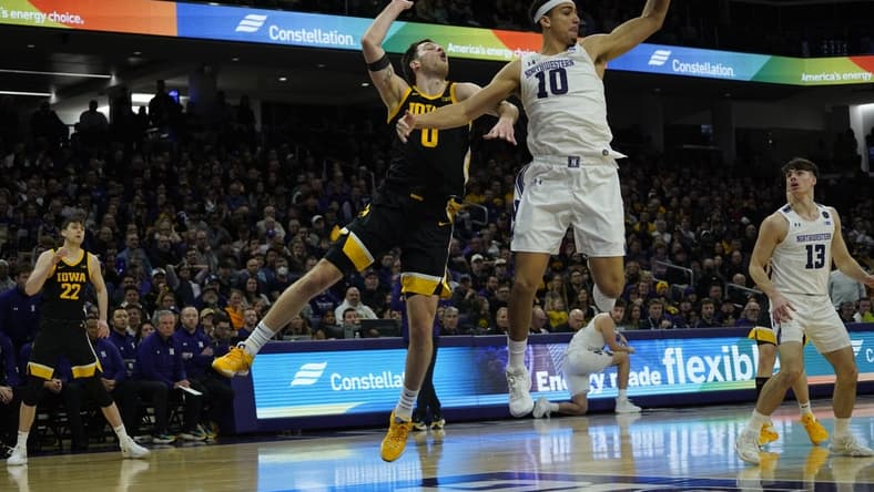 Feb 19, 2023; Evanston, Illinois, USA; Northwestern Wildcats forward Tydus Verhoeven (10) steals the ball from Iowa Hawkeyes forward Filip Rebraca (0) during the first half at Welsh-Ryan Arena. Mandatory Credit: David Banks-USA TODAY Sports
