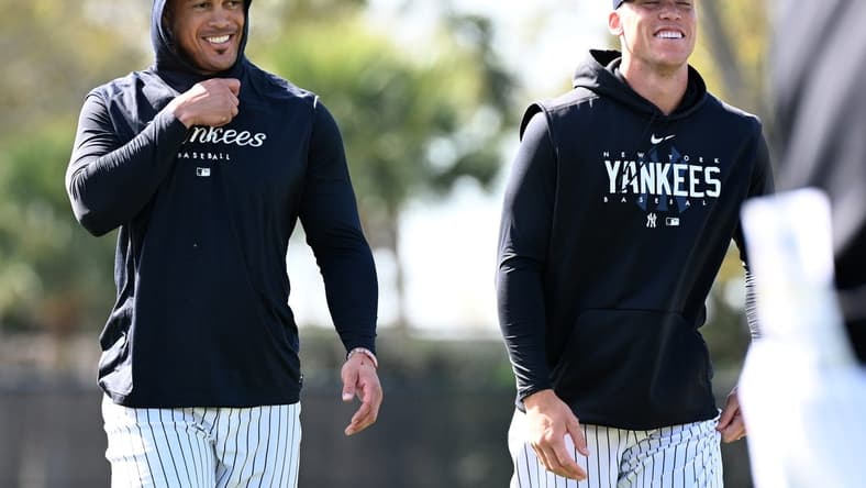 Feb 21, 2023; Tampa, FL, USA; New York Yankees outfielder Aaron Judge (99) and outfielder Giancarlo Stanton (27) warm up during spring training. Mandatory Credit: Jonathan Dyer-USA TODAY Sports