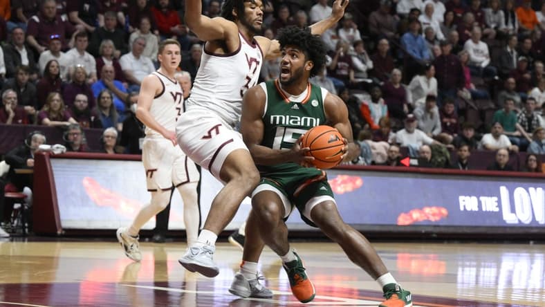 Feb 21, 2023; Blacksburg, Virginia, USA; Miami (Fl) Hurricanes forward Norchad Omier (15) drives against Virginia Tech Hokies forward Mylyjael Poteat (34) in the first half at Cassell Coliseum. Mandatory Credit: Lee Luther Jr.-USA TODAY Sports