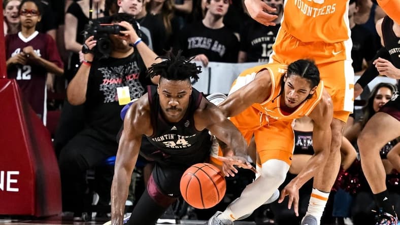 Feb 21, 2023; College Station, Texas, USA; Tennessee Volunteers guard Zakai Zeigler (5) and Texas A&M Aggies forward Julius Marble (34) fight for a loose ball during the first half at Reed Arena. Mandatory Credit: Maria Lysaker-USA TODAY Sports