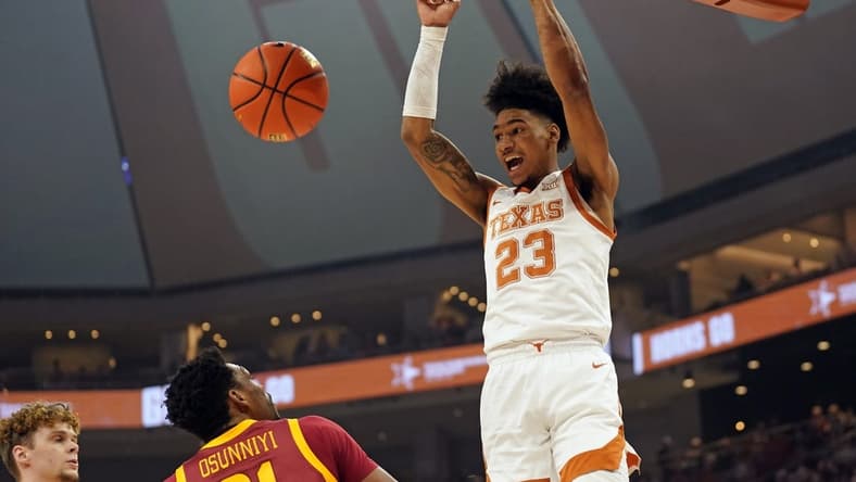 Feb 21, 2023; Austin, Texas, USA; Texas Longhorns forward Dillon Mitchell (23) dunks over Iowa State Cyclones guard Gabe Kalscheur (22) and center Osun Osunniyi (21) during the first half at Moody Center. Mandatory Credit: Scott Wachter-USA TODAY Sports
