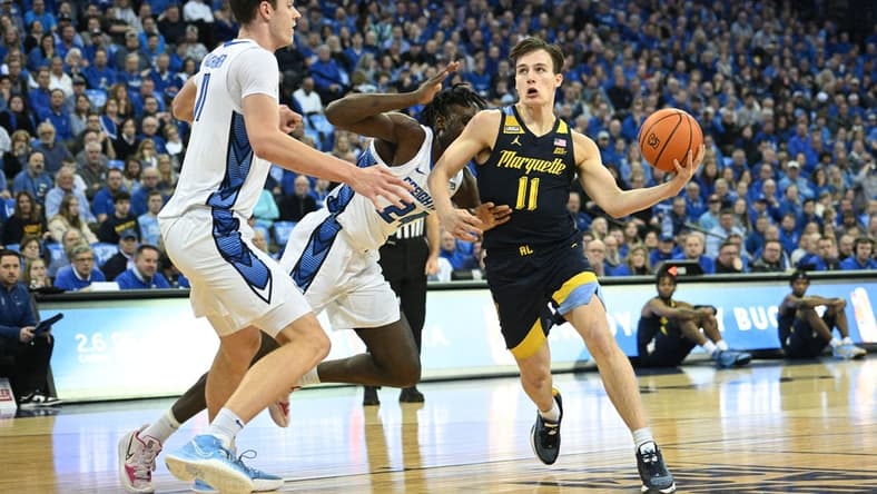 Feb 21, 2023; Omaha, Nebraska, USA; Marquette Golden Eagles guard Tyler Kolek (11) drives against Creighton Bluejays center Ryan Kalkbrenner (11) in the first half at CHI Health Center Omaha. Mandatory Credit: Steven Branscombe-USA TODAY Sports