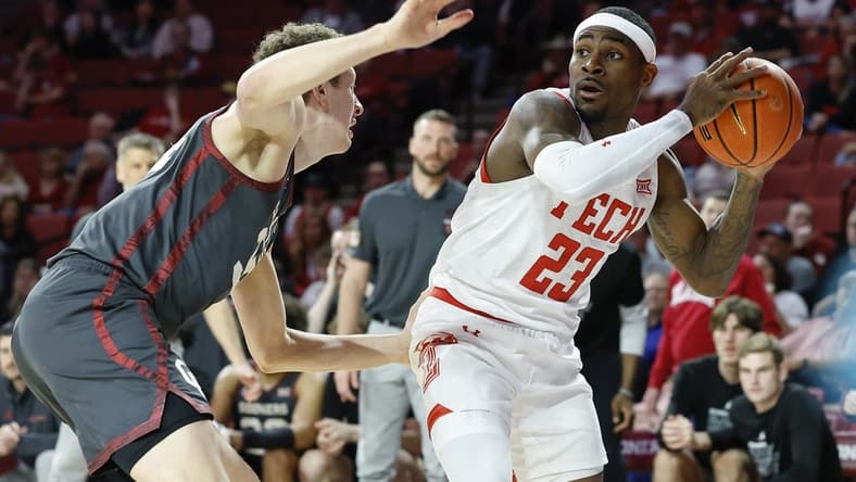 Feb 21, 2023; Norman, Oklahoma, USA; Texas Tech Red Raiders guard De'Vion Harmon (23) works to pass around Oklahoma Sooners forward Jacob Groves (34) during the first half at Lloyd Noble Center. Mandatory Credit: Alonzo Adams-USA TODAY Sports