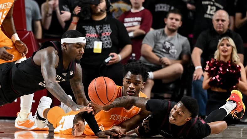 Feb 21, 2023; College Station, Texas, USA;  Texas A&M Aggies guard Wade Taylor IV (4), guard Tyrece Radford (23) and Tennessee Volunteers forward Tobe Awaka (11) dive for a loose during the second half at Reed Arena. Mandatory Credit: Maria Lysaker-USA TODAY Sports