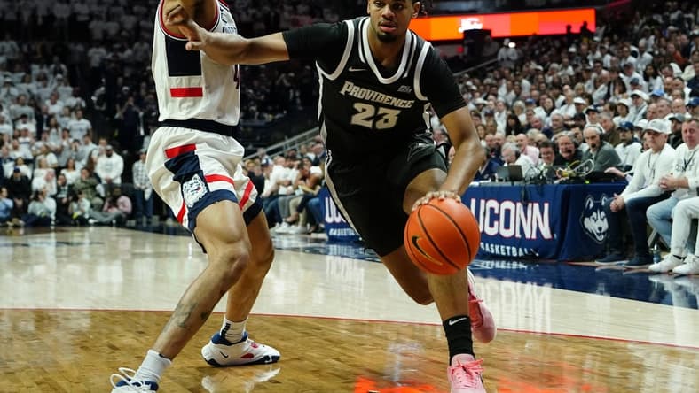 Feb 22, 2023; Storrs, Connecticut, USA; Providence Friars forward Bryce Hopkins (23) dribbles the ball against Connecticut Huskies guard Nahiem Alleyne (4) during the first half at Harry A. Gampel Pavilion. Mandatory Credit: Gregory Fisher-USA TODAY Sports