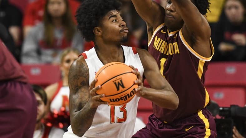 Feb 22, 2023; College Park, Maryland, USA; 13 makes a move to the basket on Minnesota Golden Gophers forward Joshua Ola-Joseph (1) during the first half at Xfinity Center. Mandatory Credit: Tommy Gilligan-USA TODAY Sports