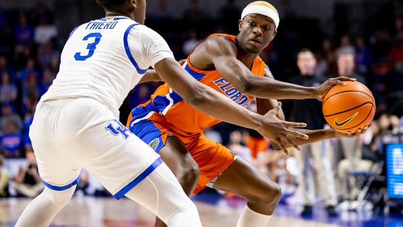 Feb 22, 2023; Gainesville, Florida, USA; Florida Gators guard Kowacie Reeves (14) attempts to pass around Kentucky Wildcats guard Adou Thiero (3) during the first half at Exactech Arena at the Stephen C. O'Connell Center. Mandatory Credit: Matt Pendleton-USA TODAY Sports