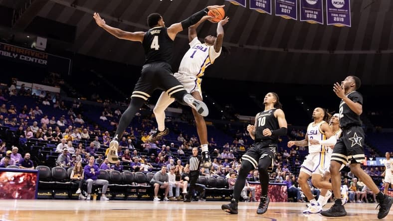 Feb 22, 2023; Baton Rouge, Louisiana, USA; LSU Tigers guard Cam Hayes (1) has a shot blocked by Vanderbilt Commodores guard Jordan Wright (4) during the first half at Pete Maravich Assembly Center. Mandatory Credit: Stephen Lew-USA TODAY Sports