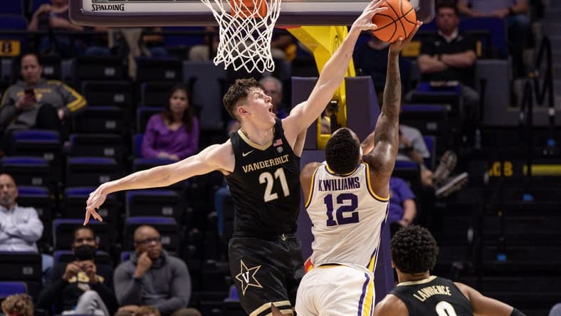 Feb 22, 2023; Baton Rouge, Louisiana, USA; Vanderbilt Commodores forward Liam Robbins (21) blocks the shot of LSU Tigers forward KJ Williams (12) during the second half at Pete Maravich Assembly Center. Mandatory Credit: Stephen Lew-USA TODAY Sports