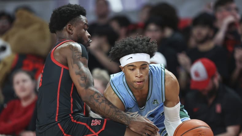 Feb 22, 2023; Houston, Texas, USA; Tulane Green Wave guard Jalen Cook (3) controls the ball as Houston Cougars guard Jamal Shead (1) defends during the first half at Fertitta Center. Mandatory Credit: Troy Taormina-USA TODAY Sports