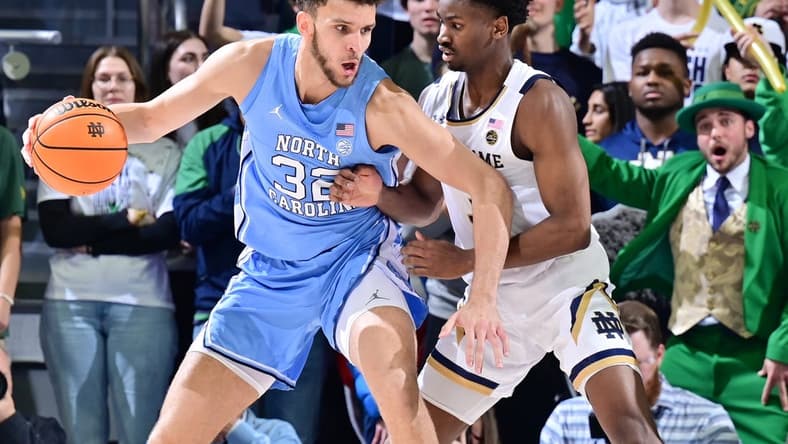 Feb 22, 2023; South Bend, Indiana, USA; North Carolina Tar Heels forward Pete Nance (32) dribbles as Notre Dame Fighting Irish guard Trey Wertz (3) defends in the second half at the Purcell Pavilion. Mandatory Credit: Matt Cashore-USA TODAY Sports