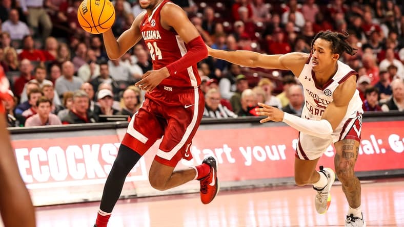 Feb 22, 2023; Columbia, South Carolina, USA; Alabama Crimson Tide forward Brandon Miller (24) drives around South Carolina Gamecocks guard Meechie Johnson (5) in the first half at Colonial Life Arena. Mandatory Credit: Jeff Blake-USA TODAY Sports