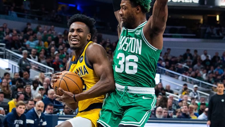 Feb 23, 2023; Indianapolis, Indiana, USA; Indiana Pacers forward Aaron Nesmith (23) shoots the ball while Boston Celtics guard Marcus Smart (36) defends in the first quarter at Gainbridge Fieldhouse. Mandatory Credit: Trevor Ruszkowski-USA TODAY Sports