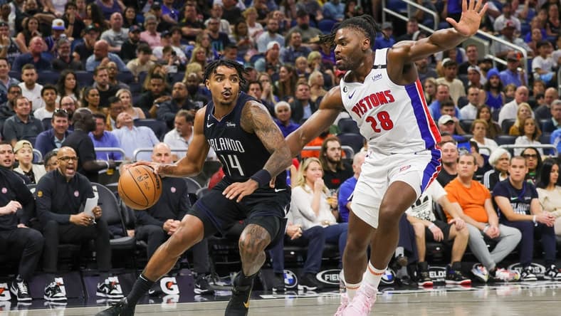 Feb 23, 2023; Orlando, Florida, USA; Orlando Magic guard Gary Harris (14) drives around Detroit Pistons center Isaiah Stewart (28) during the first quarter at Amway Center. Mandatory Credit: Mike Watters-USA TODAY Sports