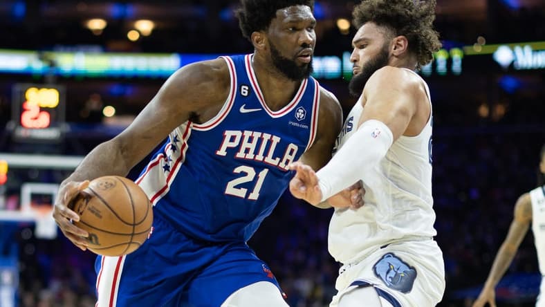 Feb 23, 2023; Philadelphia, Pennsylvania, USA; Philadelphia 76ers center Joel Embiid (21) drives against Memphis Grizzlies forward David Roddy (27) during the second quarter at Wells Fargo Center. Mandatory Credit: Bill Streicher-USA TODAY Sports