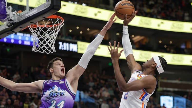 Feb 23, 2023; Salt Lake City, Utah, USA; Utah Jazz center Walker Kessler (24) blocks the shot of Oklahoma City Thunder guard Shai Gilgeous-Alexander (2) during the first quarter at Vivint Arena. Mandatory Credit: Chris Nicoll-USA TODAY Sports