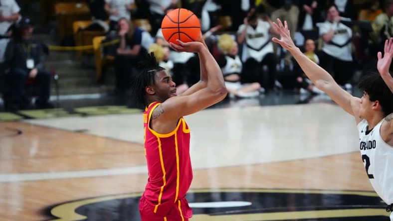 Feb 23, 2023; Boulder, Colorado, USA; USC Trojans guard Reese Dixon-Waters (2) lines up a three point basket over Colorado Buffaloes guard KJ Simpson (2) in the first half at the CU Events Center. Mandatory Credit: Ron Chenoy-USA TODAY Sports
