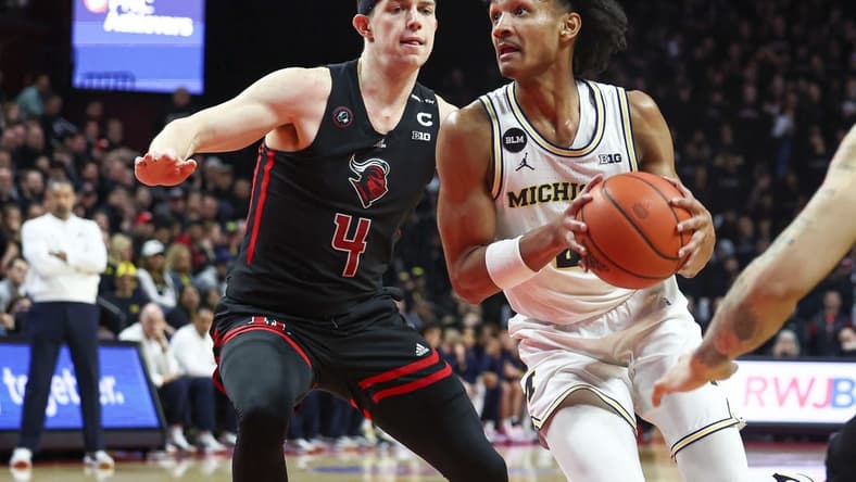 Feb 23, 2023; Piscataway, New Jersey, USA; Michigan Wolverines guard Kobe Bufkin (2) drives to the basket against Rutgers Scarlet Knights guard Paul Mulcahy (4) during the first half at Jersey Mike's Arena. Mandatory Credit: Vincent Carchietta-USA TODAY Sports