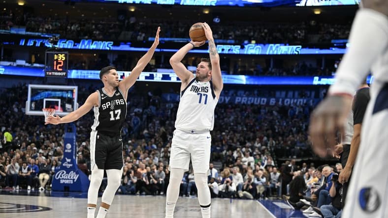 Feb 23, 2023; Dallas, Texas, USA; Dallas Mavericks guard Luka Doncic (77) shoots over San Antonio Spurs forward Doug McDermott (17) during the second quarter at the American Airlines Center. Mandatory Credit: Jerome Miron-USA TODAY Sports