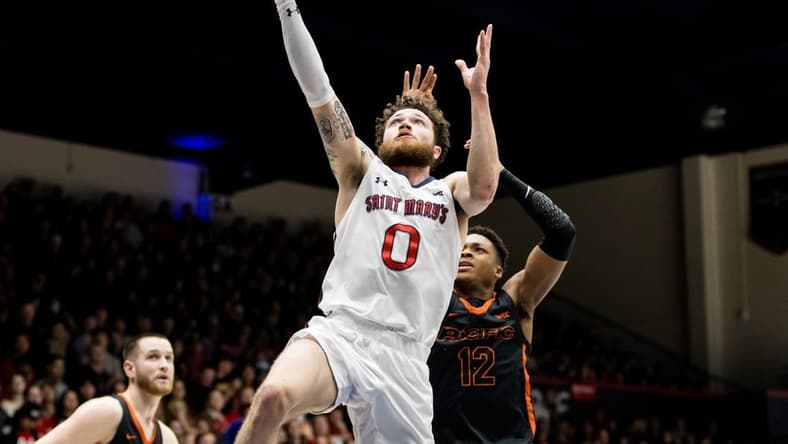 Feb 23, 2023; Moraga, California, USA; St. Mary's Gaels guard Logan Johnson (0) shoots in front of Pacific Tigers guard Jordan Ivy-Curry (12) during the first half at University Credit Union Pavilion. Mandatory Credit: John Hefti-USA TODAY Sports