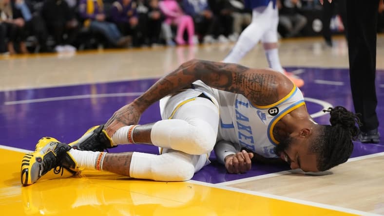 Feb 23, 2023; Los Angeles, California, USA; Los Angeles Lakers guard D'Angelo Russell (1) reacts after suffering a right ankle sprain after the game in the first half at Crypto.com Arena. Mandatory Credit: Kirby Lee-USA TODAY Sports