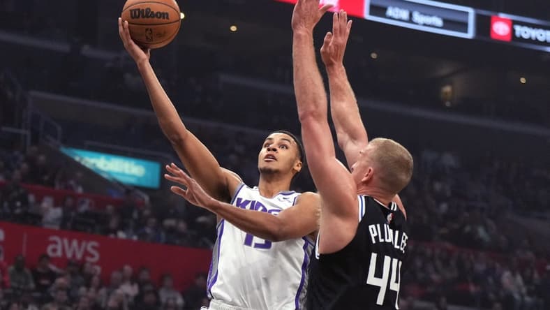 Feb 24, 2023; Los Angeles, California, USA; Sacramento Kings forward Keegan Murray (13) shoots the ball against LA Clippers center Mason Plumlee (44) in the first half at Crypto.com Arena. Mandatory Credit: Kirby Lee-USA TODAY Sports