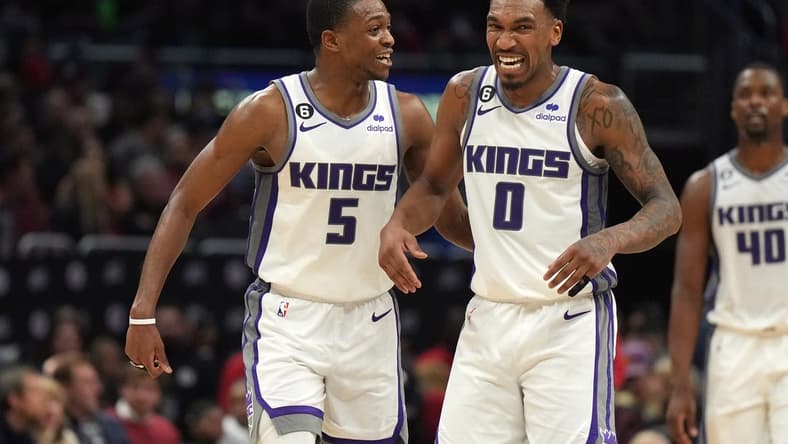 Feb 24, 2023; Los Angeles, California, USA; Sacramento Kings guard De'Aaron Fox (5) and guard Malik Monk (0) celebrate against the LA Clippers in the second half at Crypto.com Arena. The Kings defeated the Clippers 176-175 in double overtime. Mandatory Credit: Kirby Lee-USA TODAY Sports