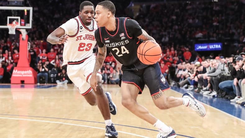 Feb 25, 2023; New York, New York, USA; Connecticut Huskies guard Jordan Hawkins (24) looks to drive past St. John's Red Storm forward David Jones (23) in the first half at Madison Square Garden. Mandatory Credit: Wendell Cruz-USA TODAY Sports