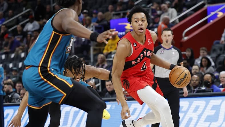 Feb 25, 2023; Detroit, Michigan, USA; Toronto Raptors forward Scottie Barnes (4) dribbles on Detroit Pistons center James Wiseman (13) in the first half at Little Caesars Arena. Mandatory Credit: Rick Osentoski-USA TODAY Sports