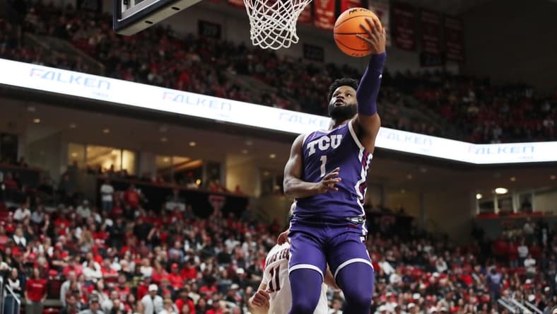 Feb 25, 2023; Lubbock, Texas, USA; TCU Horned Frogs guard Mike Miles Jr. (1) shoots the ball against Texas Tech Red Raiders forward Fardaws Aimaq (11) in the first half at United Supermarkets Arena. Mandatory Credit: Michael C. Johnson-USA TODAY Sports