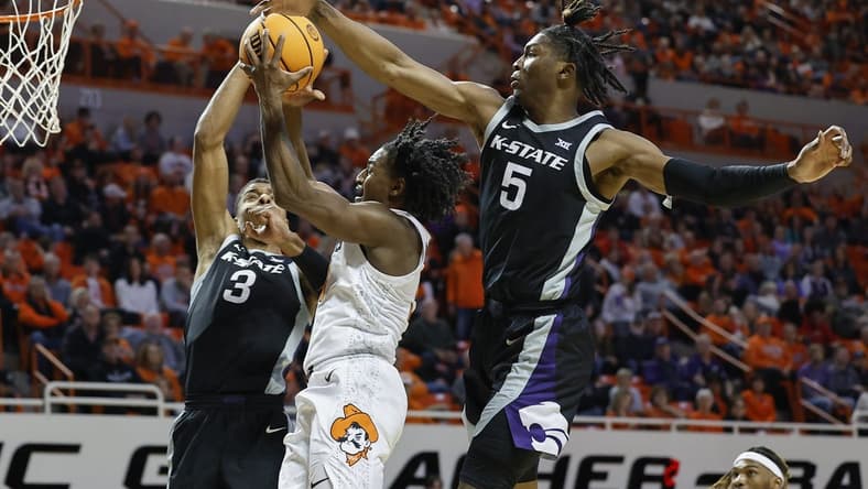 Feb 25, 2023; Stillwater, Oklahoma, USA; Oklahoma State Cowboys guard John-Michael Wright (51) goes up for a basket between Kansas State Wildcats forward David N'Guessan (3) and guard Cam Carter (5) during the first half at Gallagher-Iba Arena. Mandatory Credit: Alonzo Adams-USA TODAY Sports