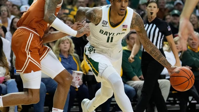 Feb 25, 2023; Waco, Texas, USA; Baylor Bears forward Jalen Bridges (11) controls the ball as Texas Longhorns forward Dillon Mitchell (23) defends during the first half at Ferrell Center. Mandatory Credit: Chris Jones-USA TODAY Sports