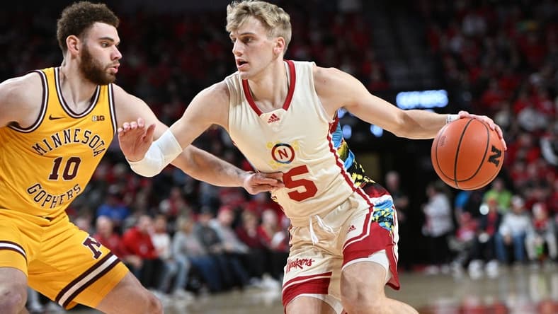 Feb 25, 2023; Lincoln, Nebraska, USA; Nebraska Cornhuskers guard Sam Griesel (5) drives against Minnesota Golden Gophers forward Jamison Battle (10) in the first half at Pinnacle Bank Arena. Mandatory Credit: Steven Branscombe-USA TODAY Sports