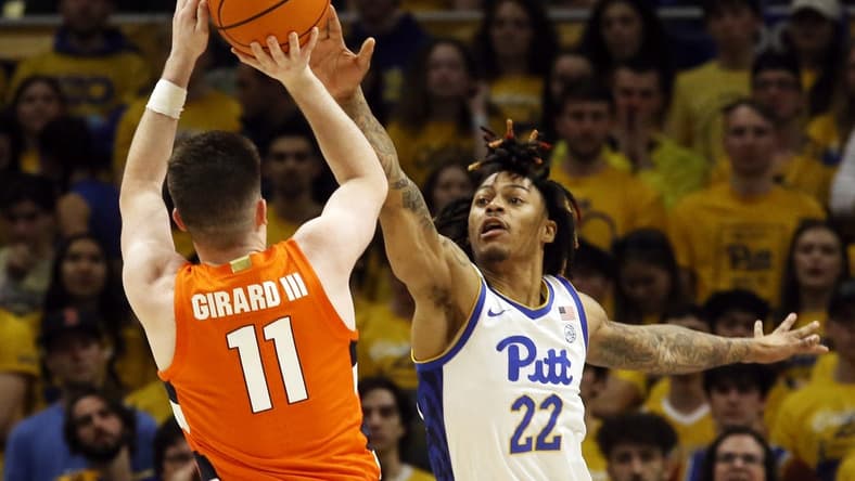 Feb 25, 2023; Pittsburgh, Pennsylvania, USA; Syracuse Orange guard Joseph Girard III (11) shoots against Pittsburgh Panthers guard Nike Sibande (22) during the first half at the Petersen Events Center. Mandatory Credit: Charles LeClaire-USA TODAY Sports