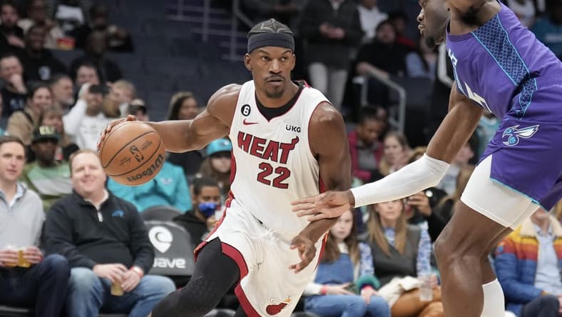 Feb 25, 2023; Charlotte, North Carolina, USA; Miami Heat forward Jimmy Butler (22) drives against Charlotte Hornets center Mark Williams (5) in the first quarter at Spectrum Center. Mandatory Credit: David Yeazell-USA TODAY Sports