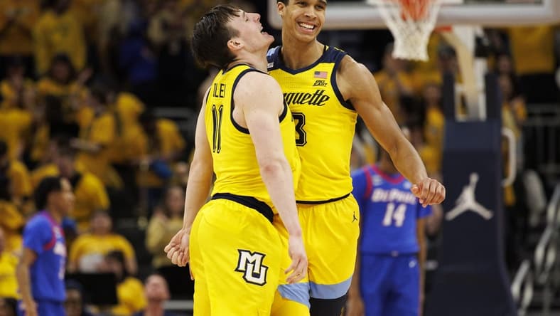 Feb 25, 2023; Milwaukee, Wisconsin, USA; Marquette Golden Eagles forward Oso Ighodaro (13) celebrates with guard Tyler Kolek (11) following a made basket during the first half against the DePaul Blue Demons at Fiserv Forum. Mandatory Credit: Jeff Hanisch-USA TODAY Sports