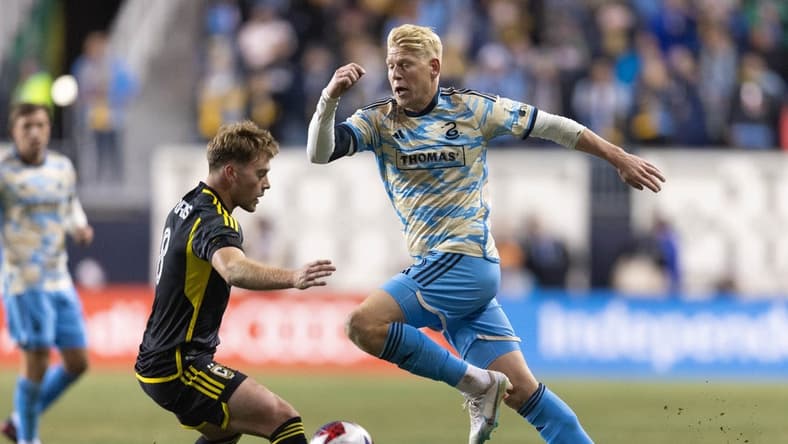 Feb 25, 2023; Philadelphia, Pennsylvania, USA; Philadelphia Union defender Jakob Glesnes (5) dribbles past Columbus Crew SC midfielder Aidan Morris (8) during the first half at Subaru Park. Mandatory Credit: Bill Streicher-USA TODAY Sports