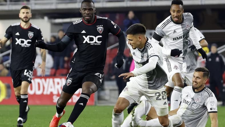 Feb 25, 2023; Washington, District of Columbia, USA;  D.C. United forward Christian Benteke (20) and Toronto FC defender Raoul Petretta (28) battle for the ball during the second half at Audi Field. Mandatory Credit: Geoff Burke-USA TODAY Sports