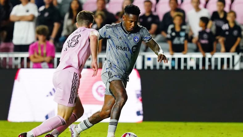 Feb 25, 2023; Fort Lauderdale, Florida, USA; CF Montreal forward Romell Quioto (30) dribbles the ball against Inter Miami CF defender Harvey James Neville (18) during the second half at DRV PNK Stadium. Mandatory Credit: John David Mercer-USA TODAY Sports