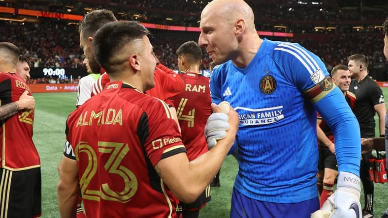 Feb 25, 2023; Atlanta, Georgia, USA; Atlanta United FC midfielder Thiago Almada (23) celebrates with goalkeeper Brad Guzan (1) after the game against the San Jose Earthquakes at Mercedes-Benz Stadium. Mandatory Credit: Brett Davis-USA TODAY Sports