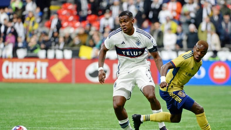 Feb 25, 2023; Vancouver, British Columbia, CAN; Vancouver Whitecaps FC forward Sergio Cordova (9) battles for the ball against Real Salt Lake midfielder Andres Gomez (11) during the second half at BC Place. Mandatory Credit: Anne-Marie Sorvin-USA TODAY Sports