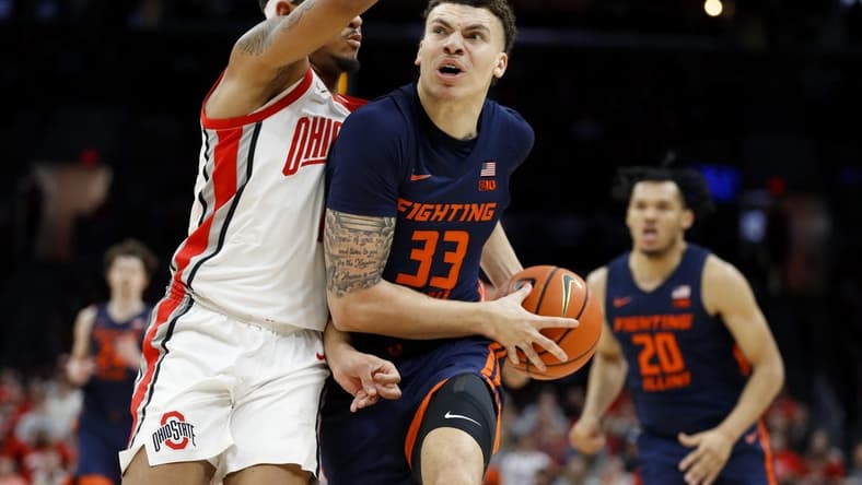 Feb 26, 2023; Columbus, Ohio, USA; Illinois Fighting Illini forward Coleman Hawkins (33) drives in for the score as Ohio State Buckeyes guard Roddy Gayle Jr. (1) defends during the first half at Value City Arena. Mandatory Credit: Joseph Maiorana-USA TODAY Sports
