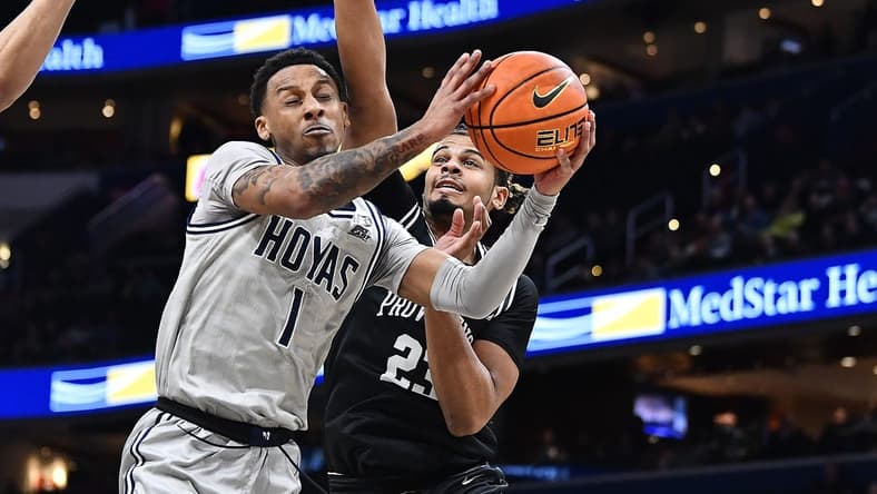 Feb 26, 2023; Washington, District of Columbia, USA; Georgetown Hoyas guard Primo Spears (1) is fouled by Providence Friars forward Bryce Hopkins (23) during the first half at Capital One Arena. Mandatory Credit: Brad Mills-USA TODAY Sports