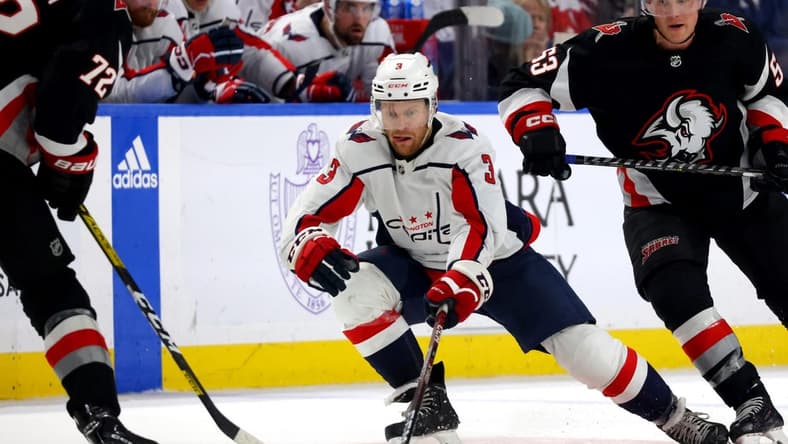 Feb 26, 2023; Buffalo, New York, USA;  Washington Capitals defenseman Nick Jensen (3) reaches for the puck during the third period against the Buffalo Sabres at KeyBank Center. Mandatory Credit: Timothy T. Ludwig-USA TODAY Sports