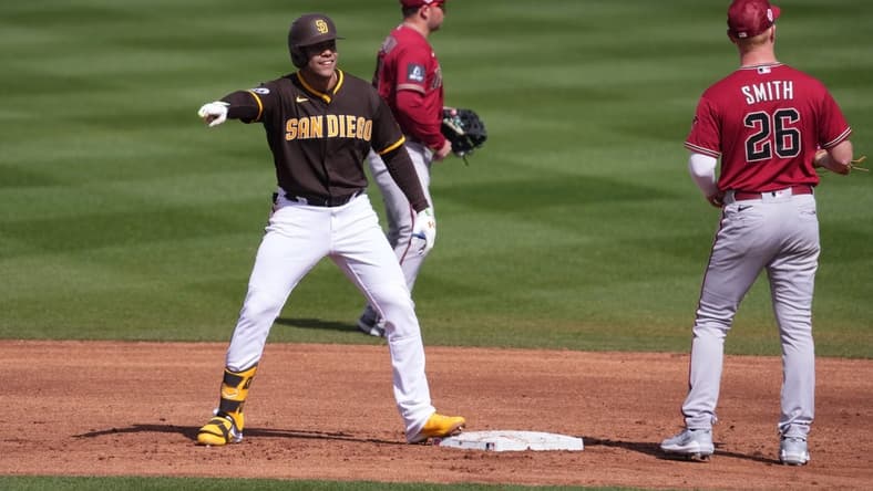 Feb 26, 2023; Peoria, Arizona, USA; San Diego Padres right fielder Juan Soto (22) celebrates a double against the Arizona Diamondbacks during the second inning at Peoria Sports Complex. Mandatory Credit: Joe Camporeale-USA TODAY Sports