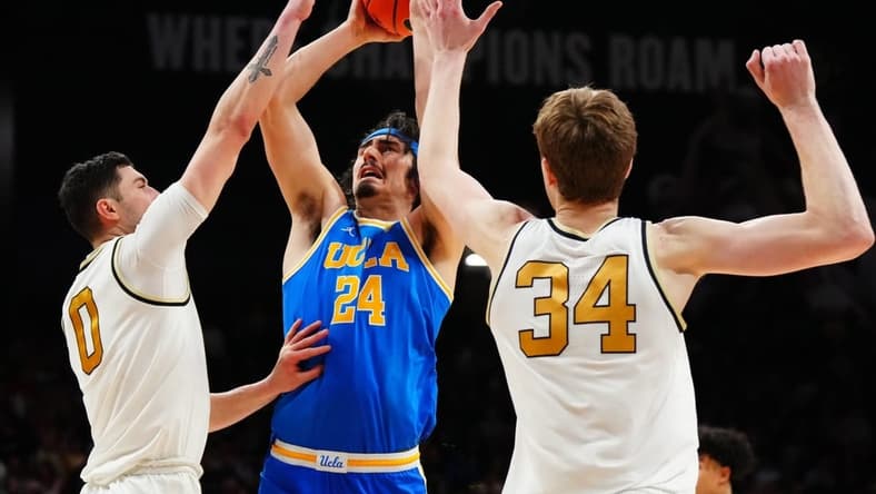 Feb 26, 2023; Boulder, Colorado, USA; UCLA Bruins guard Jaime Jaquez Jr. (24) shoots the ball between Colorado Buffaloes guard Luke O'Brien (0) and center Lawson Lovering (34) in the second half at the CU Events Center. Mandatory Credit: Ron Chenoy-USA TODAY Sports