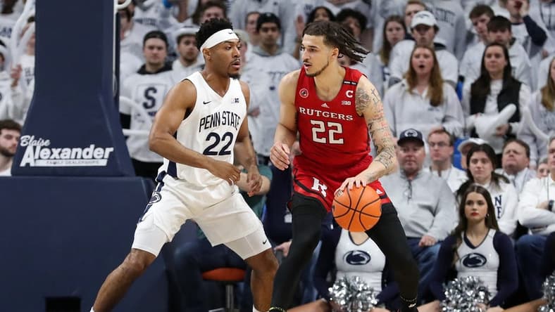 Feb 26, 2023; University Park, Pennsylvania, USA; Rutgers Scarlet Knights guard Caleb McConnell (22) dribbles the ball towards the basket as Penn State Nittany Lions guard Jalen Pickett (22) defends during the first half at Bryce Jordan Center. Mandatory Credit: Matthew OHaren-USA TODAY Sports