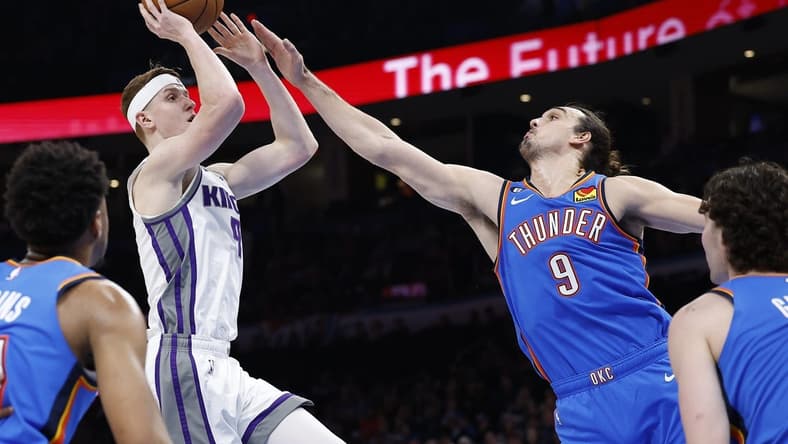Feb 26, 2023; Oklahoma City, Oklahoma, USA; Oklahoma City Thunder forward Dario Saric (9) defends a shot by Sacramento Kings guard Kevin Huerter (9) during the second quarter at Paycom Center. Mandatory Credit: Alonzo Adams-USA TODAY Sports