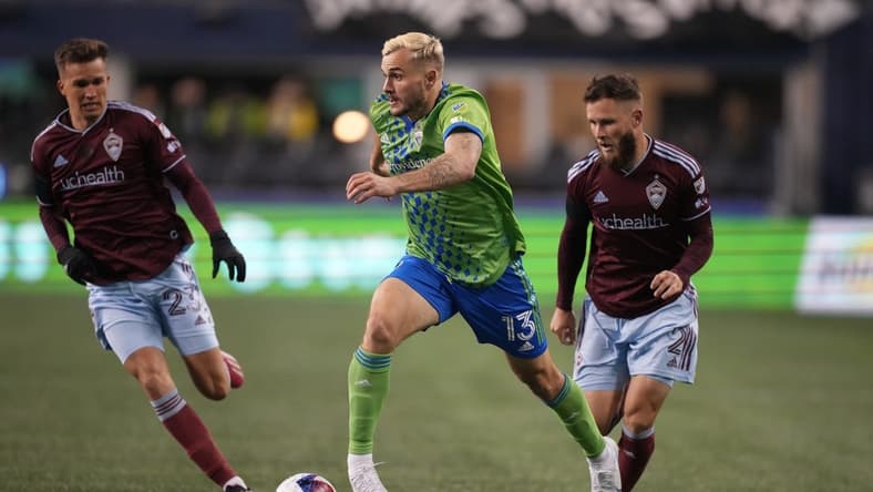 Feb 26, 2023; Seattle, Washington, USA; Seattle Sounders FC forward Jordan Morris (13) dribbles the ball defended by Colorado Rapids defender Keegan Rosenberry (2) in the second half at Lumen Field. Mandatory Credit: Kirby Lee-USA TODAY Sports