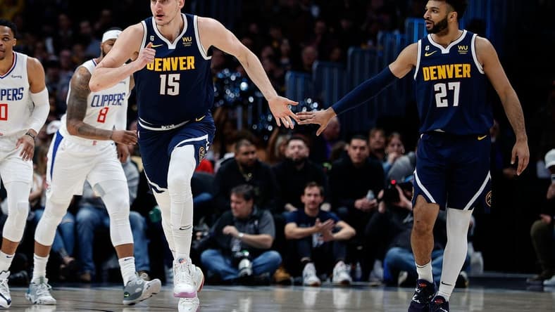 Feb 26, 2023; Denver, Colorado, USA; Denver Nuggets center Nikola Jokic (15) reacts with guard Jamal Murray (27) after a play in the first quarter against the Los Angeles Clippers at Ball Arena. Mandatory Credit: Isaiah J. Downing-USA TODAY Sports